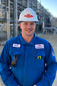 Garnet Carmichael wearing hard hat and smiling at camera