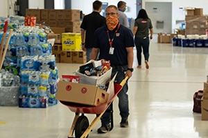 Dow volunteer moves a load of relief supplies