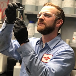 Dow employee inspects hand sanitizer sample