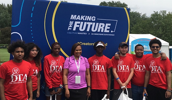 Karen Carter poses with Dow Treasury Academy participants at Dow Great Lakes Bay Invitational.